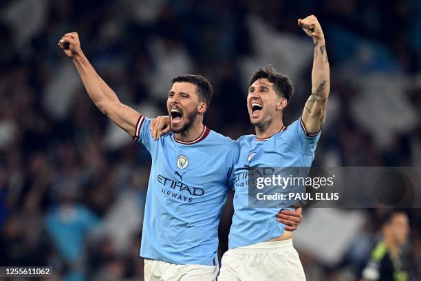 Manchester City's Portuguese defender Ruben Dias and Manchester City's English defender John Stones celebrates after the UEFA Champions League second...