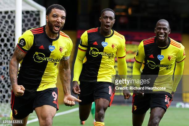 Troy Deeney of Watford celebrates with teammates after scoring his team's second goal from a penalty during the Premier League match between Watford...