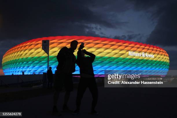 General view outside of the soccer stadium Allianz Arena which is illuminated in rainbow colours for Christopher Street Day on July 11, 2020 in...