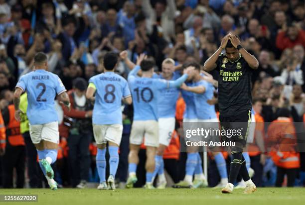 Rodrygo of Real Madrid gestures as Kevin De Bruyne of Manchester City celebrates with teammates after scoring a goal during the UEFA Champions League...