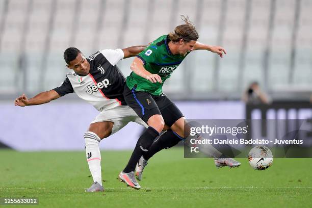 Alex Sandro of Juventus is challenged by Hans Hateboer of Atalanta BC during the Serie A match between Juventus and Atalanta BC at Allianz Stadium on...