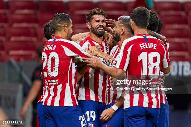 Diego Costa of Club Atletico de Madrid celebrates with teammates after scoring his team's first goal during the Liga match between Club Atletico de...