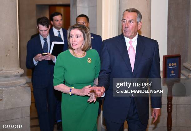 Former US House Speakers Nancy Pelosi and John Boehner walk to a portrait unveiling for former US House Speaker Paul Ryan at the US Capitol in...