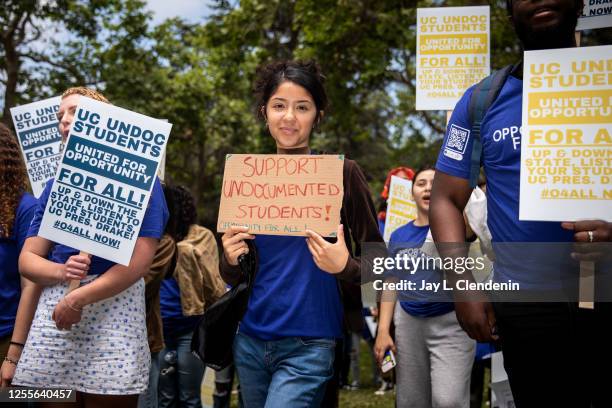 Los Angeles, CA Daniela Valadez, a UCLA student majoring in labor studies, holds a sign that reads, "Support undocumented students! Opportunity for...