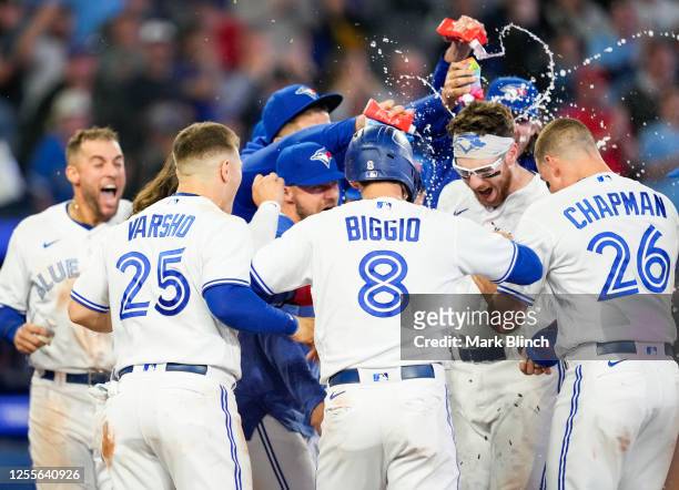 Danny Jansen of the Toronto Blue Jays celebrates his walk off three run home run to defeat the New York Yankees in the ninth inning during their MLB...