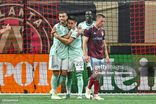 Atlanta forward Tyler Wolff is congratulated by teammate Giorgos Giakoumakis after Wolff scored a goal during the MLS match between the Colorado...