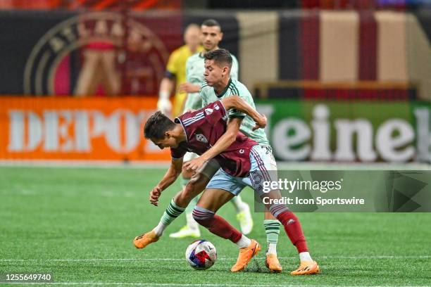 Colorado midfielder Danny Leyva receives a challenge from Atlanta midfielder Matheus Rossetto during the MLS match between the Colorado Rapids and...