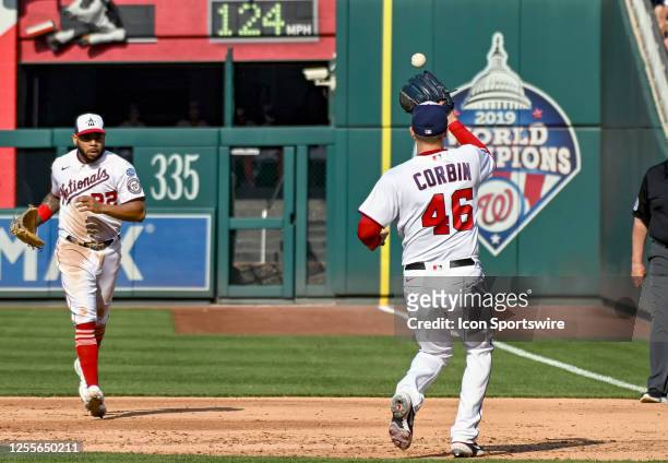 May 15: Washington Nationals first baseman Dominic Smith tosses the ball to starting pitcher Patrick Corbin to retire the runner during the New York...