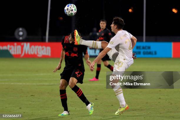 Sean Davis of New York Red Bulls goes for the ball against Emerson Hyndman of Atlanta United during a match in the MLS Is Back Tournament at ESPN...