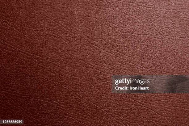 brown genuine text and background of leather - leder stock-fotos und bilder