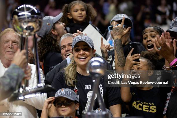 Las Vegas Aces owner Mark Davis, left, and head coach Becky Hammon stand alongside their cheering team as they receive the 2022 WNBA Championship...