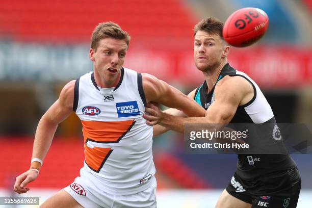 Aidan Corr of the Giants and Robbie Gray of the Power compete for the ball during the round 6 AFL match between the Port Adelaide Power and the...