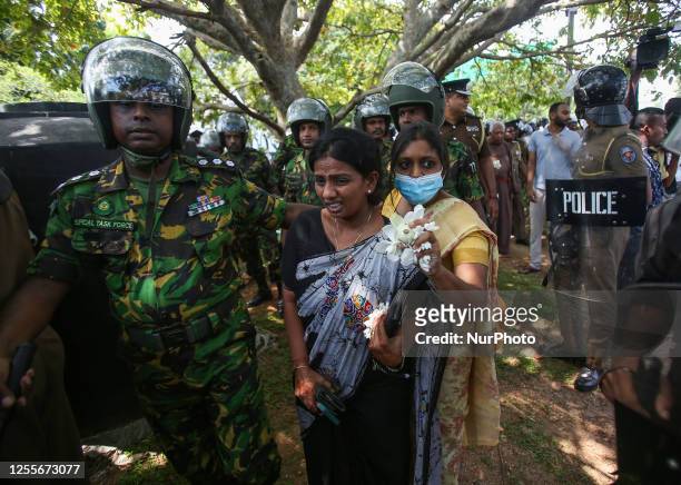 Two Tamil women were protected by Special Forces soldiers when a group of people protested against the 14th anniversary of the Civil War, in Colombo...