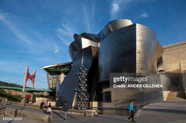 This picture taken on April 27, 2023 shows a general view of Canadian-American architect Frank Gehry's Guggenheim Bilbao Museum, next to French...