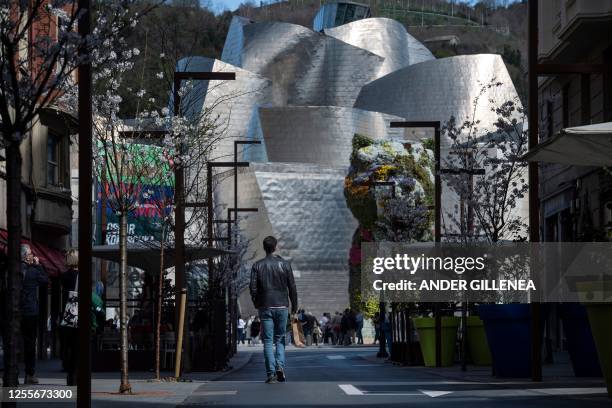 Artist Jeff Koons' "Puppy" is seen next to Canadian-American architect Frank Gehry's Guggenheim Bilbao Museum in the Spanish Basque city of Bilbao on...