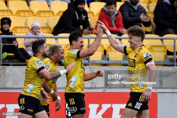 Kobus Van Wyk of the Hurricanes celebrates with team mates after scoring a try during the round 5 Super Rugby Aotearoa match between the Hurricanes...