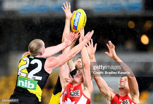 Chad Warner of the Swans and Josh Caddy of the Tigers challenge for the mark during the round 6 AFL match between the Richmond Tigers and the Sydney...