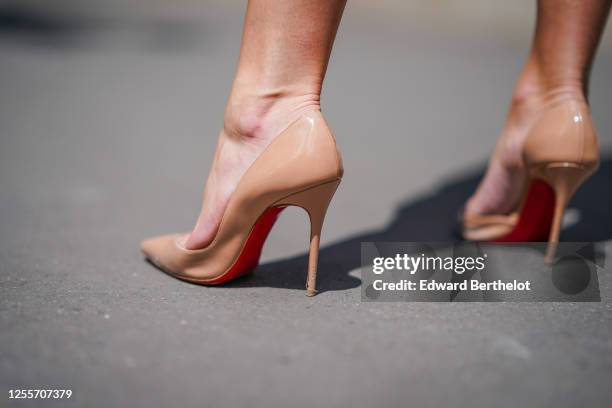 Lexi Fargo wears Louboutin beige high heeled pointy shoes with red soles, on July 11, 2020 in Paris, France.