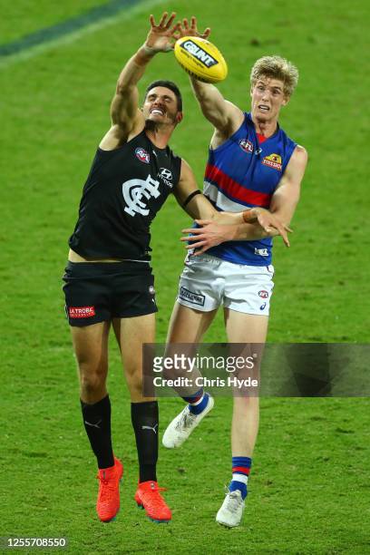 Marc Piitonet of the Blues and Tim English of the Bulldogs compete for the ball during the round 6 AFL match between the Carlton Blues and the...