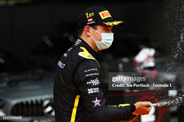 Race winner Christian Lundgaard of Denmark and ART Grand Prix celebrates on the podium during the sprint race for the Formula 2 Championship at Red...