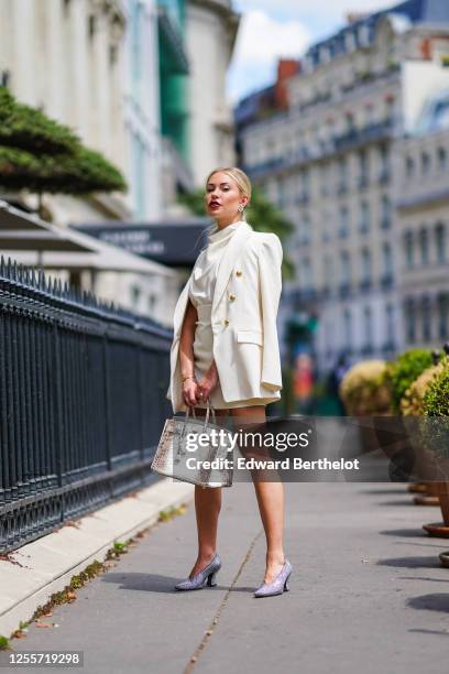 Lexi Fargo wears a white Zara oversized blazer jacket, a white Zara blouse, a Zara skirt, Chanel earrings, a brown and white Hermes Himalayan Birkin...