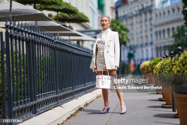 Lexi Fargo wears a white Zara oversized blazer jacket, a white Zara blouse, a Zara skirt, Chanel earrings, a brown and white Hermes Himalayan Birkin...