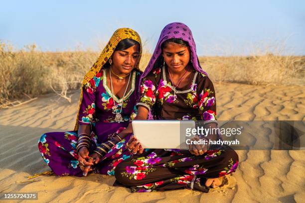happy gypsy indian girls using digital tablet, india - rajasthani women stock pictures, royalty-free photos & images