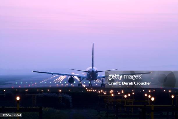 aeroplane on runway awaiting takeoff. - gatwick airport stock pictures, royalty-free photos & images