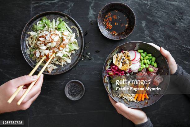 friends eating tradition japanese dishes for family dinner. - rice bowl stock-fotos und bilder