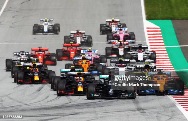 Lewis Hamilton of Great Britain driving the Mercedes AMG Petronas F1 Team Mercedes W11 leads the field at the start of the race into the first corner...