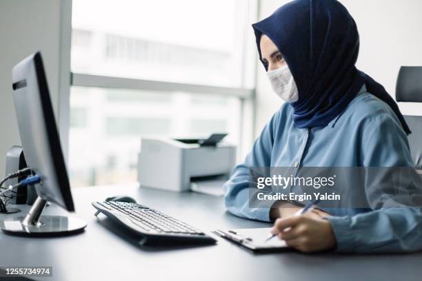 muslim girl in hijab working in office - student mask stock pictures, royalty-free photos & images