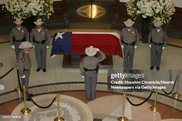 Texas Department of Public safety officer salutes during the changing of the guard during the public visitation for former Texas State Governor Ann...