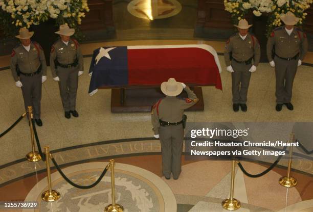 Texas Department of Public saftey officer salutes during the changing of the guard during the public visitation for former Texas State Governor Ann...