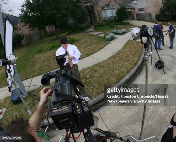 Reporter prepares for a television live shot outside NASA astronaut Lisa Nowak's home in Houston, Texas February 7,2007. Nowak has been charge with...