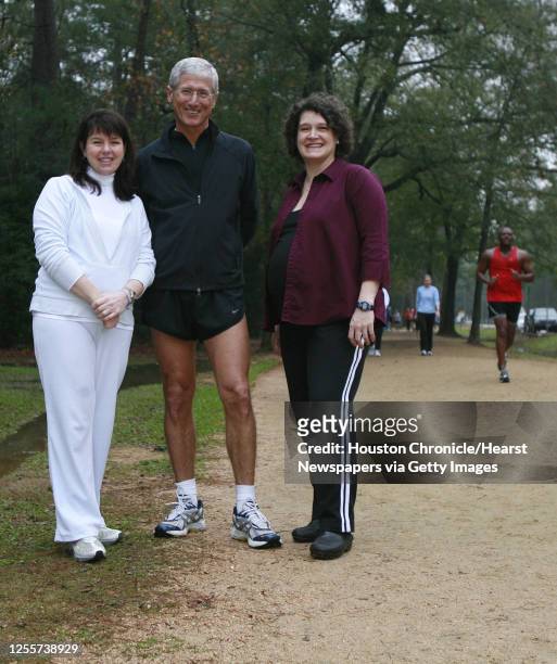 Dolph Tillotson and Jennifer Perez and Lynlee Linke stand near the spot along Memorial Park's jogging trail where Tillotson suffered a heart attack...