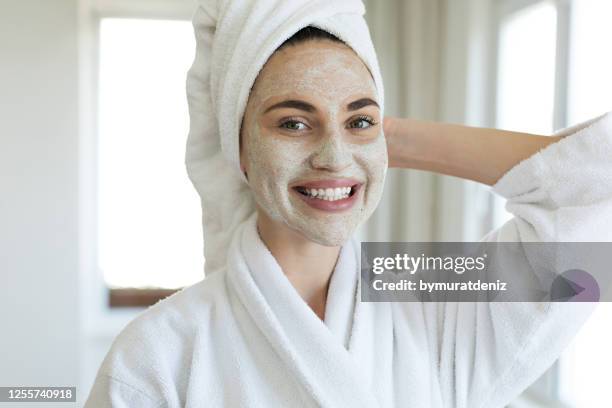 giovane donna in piedi con una maschera facciale - aspetto naturale foto e immagini stock