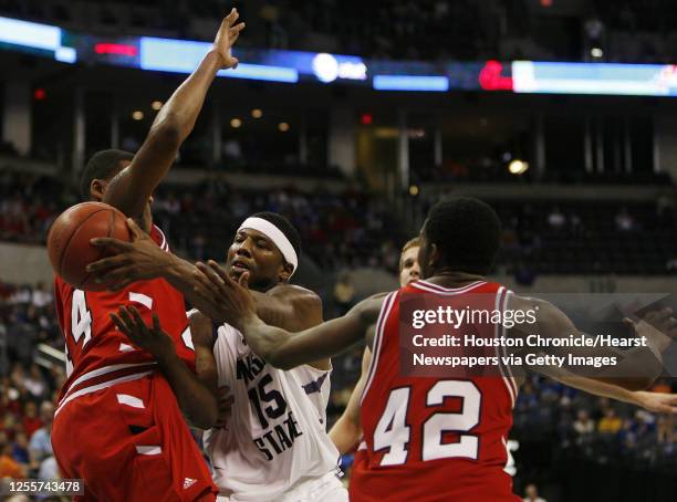 Kansas State's David Hoskins passes the ball between Texas Tech's Darryl Dora and Charlie Burgess during the second half of Phillips 66 Big 12 Men's...