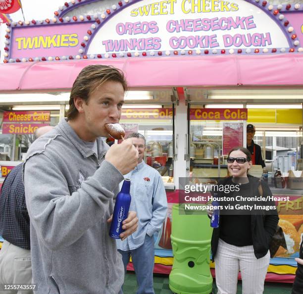Mark Martin of Manhattan Beach, California tries a fried twinkie the Sweet Cheeks booth at the carnival and midway at the Houston Livestock Show and...