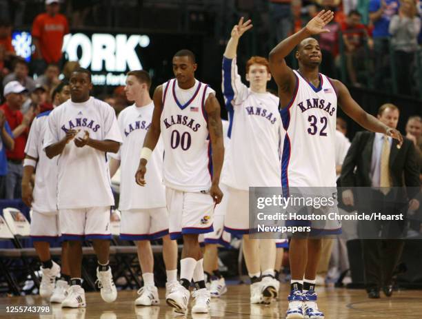 Kansas' Darnell Jackson holds a hand in the air after Kansas defeated Kansas State 67-61 in Phillips 66 Big 12 Men's Basketball Championship...