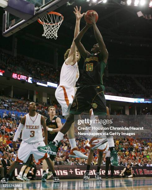 The University of Texas' Matt Hill blocks a shot by Baylor's Mamadou Diene during the half of Phillips 66 Big 12 Men's Basketball Championship...