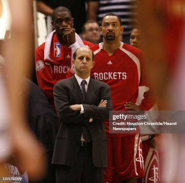 The Houston Rockets head coach Jeff Van Gundy stands in front of Dikembe Mutombo and Jawan Howard near the end of game 3 of the NBA Western...