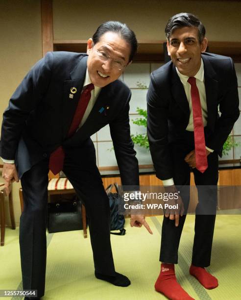 Prime Minister Rishi Sunak shows off his socks to Japanese Prime Minister Fumio Kishida, which has the name of Kishida's favorite baseball team,...