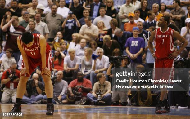 The Houston Rockets Yao Ming and Tracy McGrady stand on the court near the end of the fourth quarter of game six in the first round of the NBA...