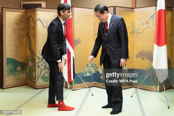 Prime Minister Rishi Sunak shows off his socks to Japanese Prime Minister Fumio Kishida, which has the name of Kishida's favorite baseball team,...