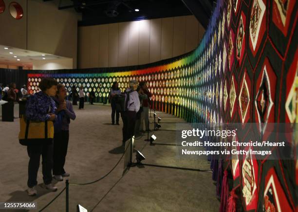 Gale Wilson and Linda Roberts of Huntsville, Texas view a giant Canadian quilt called "Quilt of Belonging" which is 10 feet high and a 120 feet long...