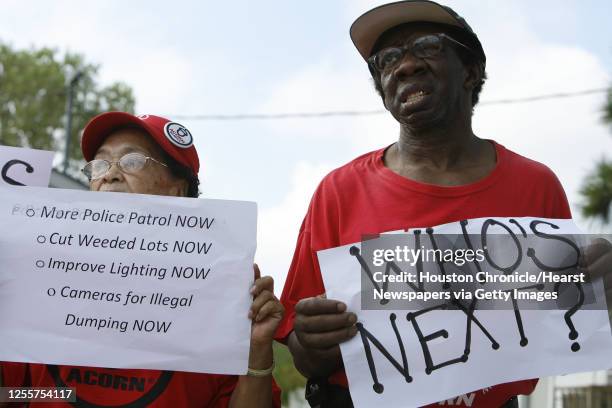 Lillie Yett and Charles Mitchell hold up signs during a press conference held by the Acres Homes chapter of ACORN demanding the City of Houston take...