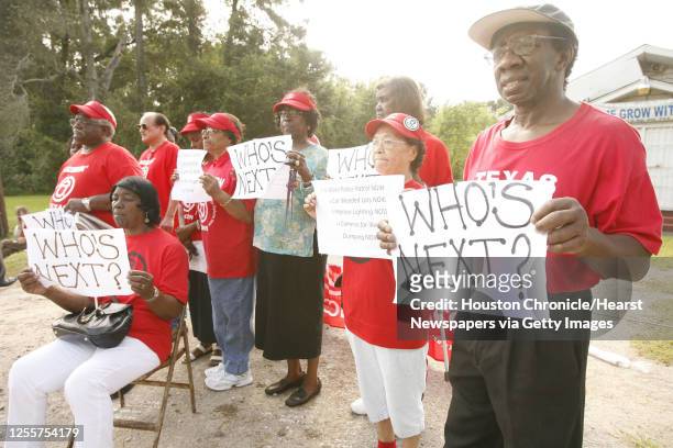 Acres Homes resident hold up signs during a press conference held by the Acres Homes chapter of ACORN demanding the City of Houston take action now...
