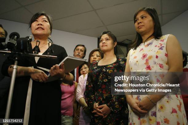 Year-old Raymond Liu's aunts Connie Diep and Ling Liu listen as Asian American Family Services Executive Director Kim Szeto speaks during a press...