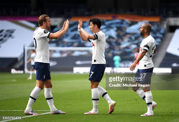 Heung-Min Son of Tottenham Hotspur celebrates with Harry Kane of Tottenham Hotspur after he scores his teams first goal during the Premier League...