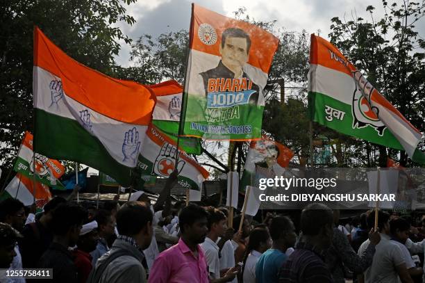 Activists and supporters of Congress party hold party's flags as they take part in a rally to celebrate the victory in Karnataka state assembly...